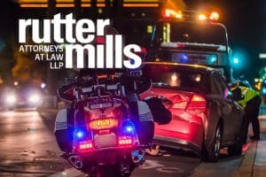 Motorcycle accident scene with tow truck and damaged car